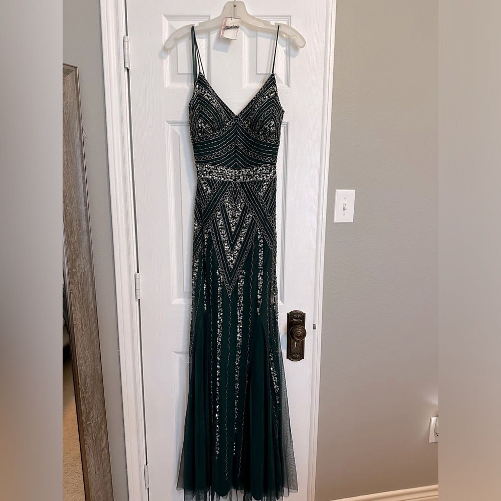 Hunter green V-neck beaded bread with godets. Size 6.